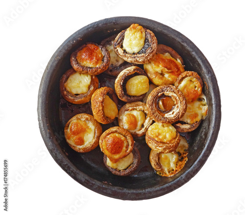 Georgian cuisine: mushrooms baked with cheese suluguni on ketsi, isolated on white background