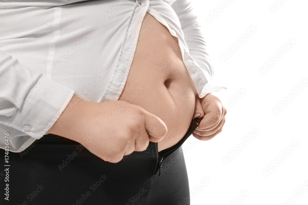 Overweight woman in tight clothes on white background closeup. Weight loss concept Stock Photo Adobe Stock