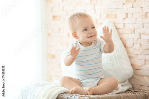 Cute little baby sitting on...