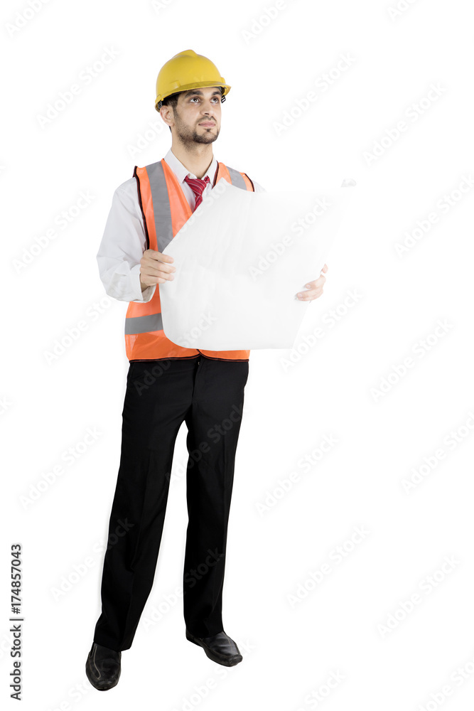 Handsome architect holds blueprint in studio Handsome architect holds blueprint in studio