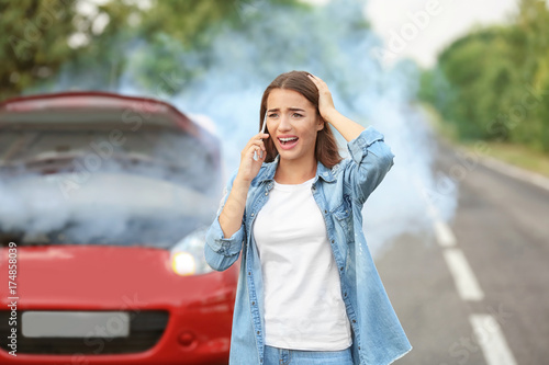 Upset young woman with cell...
