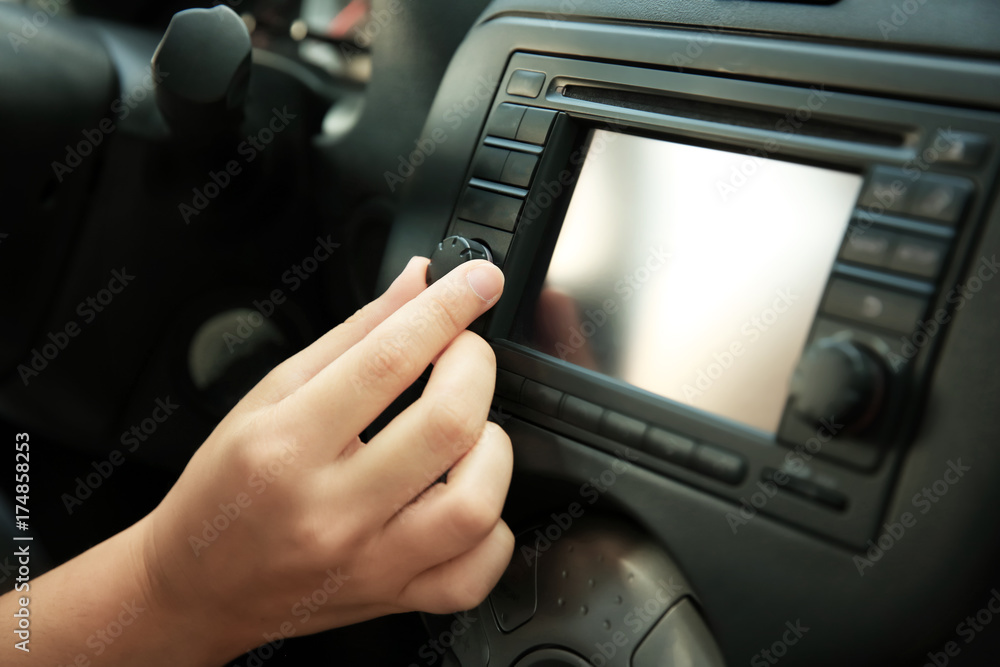 Woman tuning radio in car, closeup Woman tuning radio in car, closeup