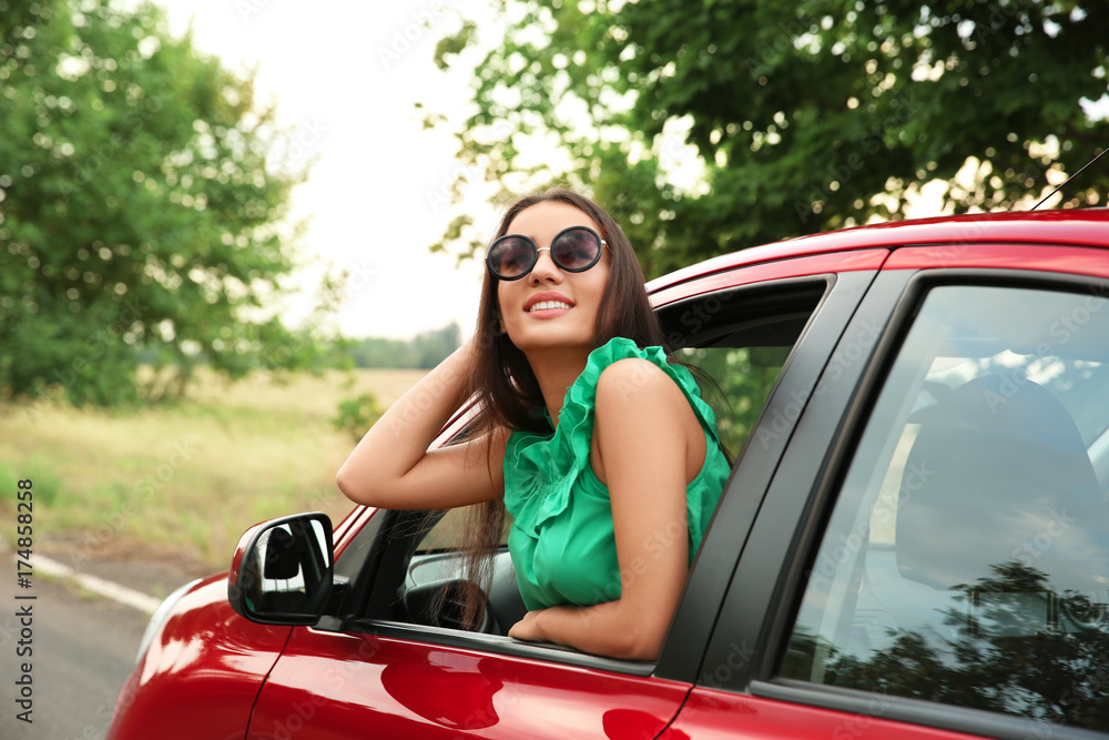 Fototapeta premium Woman looking out of car window