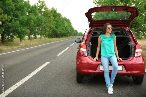 Young woman standing near c...