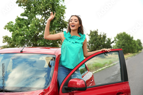 Young woman looking out of car