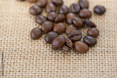 Fototapeta Naklejka Na Ścianę i Meble -  Coffee bean.Roasted coffee bean on burlap background.