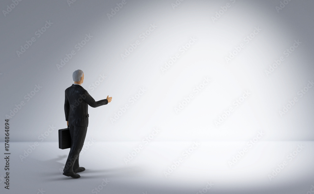 toy miniature businessman figure standing and looking at bright empty white lit space, concept background toy miniature businessman figure standing and looking at bright empty white lit space, concept background