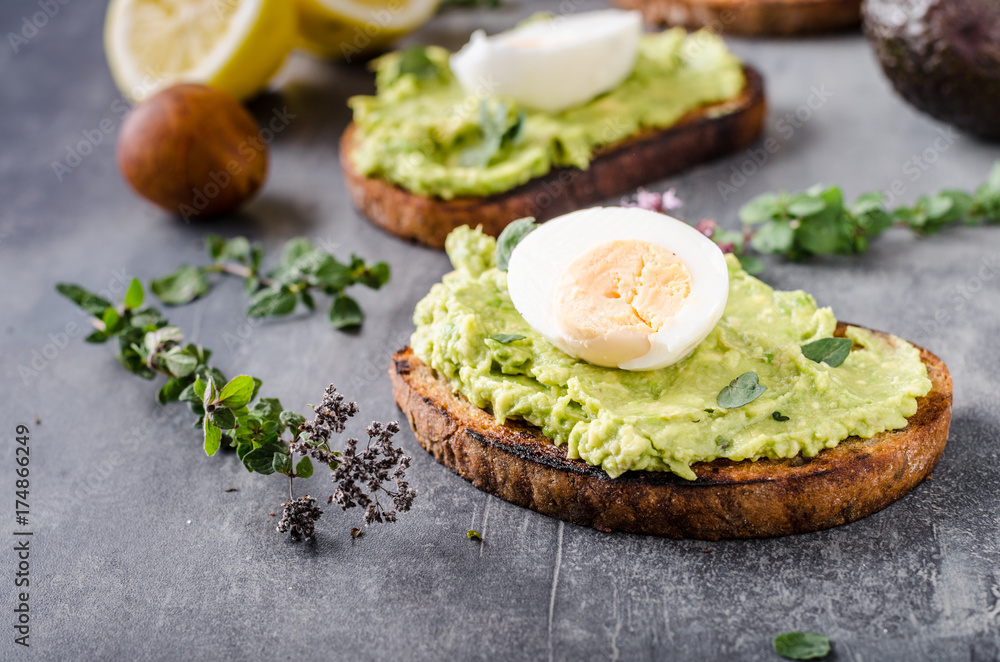 Bio avocado on bread with boiled egg