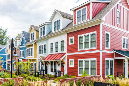Фототапет Row of colorful, red, yellow, blue, white, green painted residential townhouses,