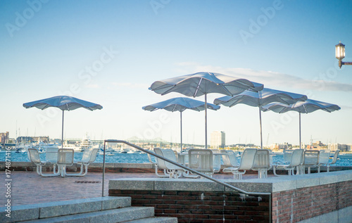 Patio with umbrella chairs moakley courthouse on waterfront in boston seaport