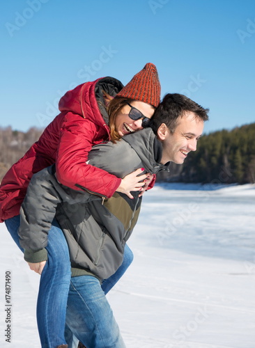 Happy couple having fun on a frozen lake