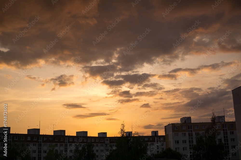 Golden sunset with silhouette of houses and hills. Slovakia