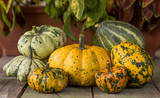 Colorful pumpkins on a rustic wooden table