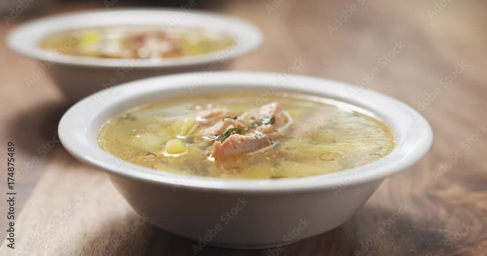 Slow motion closeup seasoning with pepper fish soup with salmon Slow motion closeup seasoning with pepper fish soup with salmon