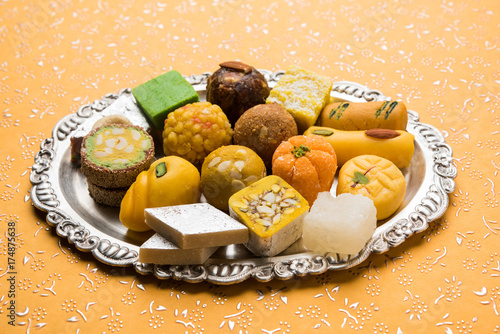 Canvas Print Stock photo of Indian sweets served in silver or wooden plate