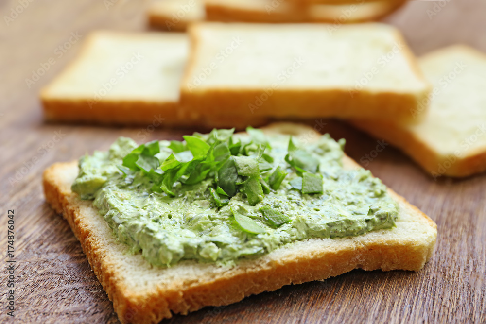 Bread with tasty spinach sauce on table, close up Bread with tasty spinach sauce on table, close up