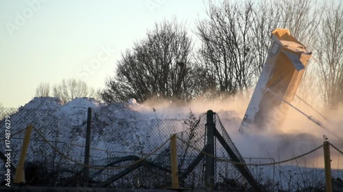 Soda ash being tipped onto a pile on an industrial site.