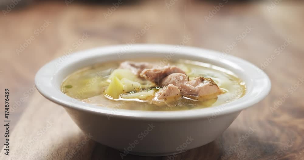 Slow motion closeup seasoning with pepper fish soup with salmon Slow motion closeup seasoning with pepper fish soup with salmon