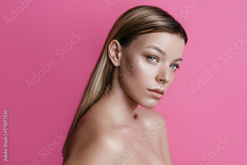 beautiful girl with natural make-up on a pink background