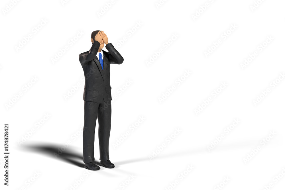 toy miniature businessman figure covering his eyes in front of an empty space, concept isolated with shadow on white background toy miniature businessman figure covering his eyes in front of an empty space, concept isolated with shadow on white background