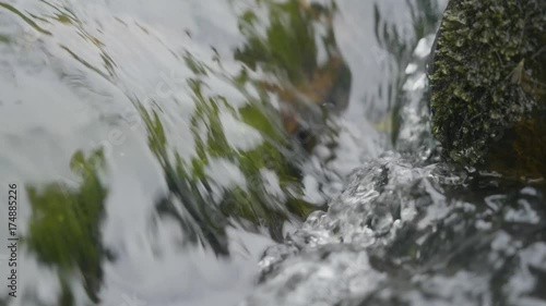 Water in river close up. Pebble stones in the river water close up view photo