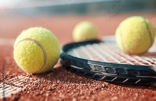 Tennis ball with racket on the tennis court. Sport, recreation concept © bobex73