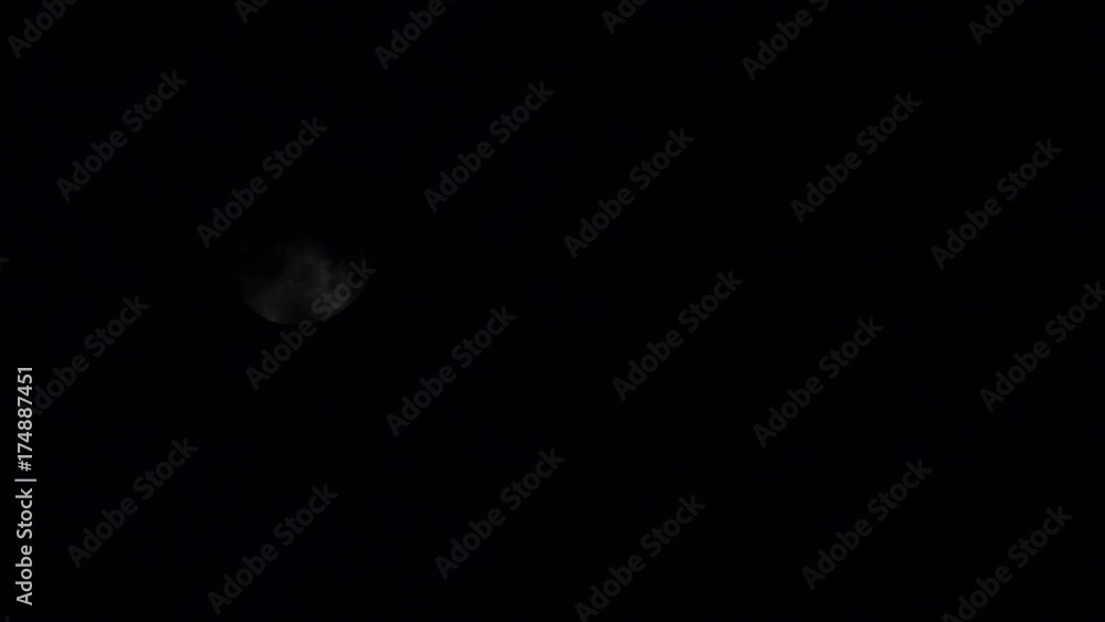Full moon at night on dark black sky behind moving clouds, moonlight 4K ProRes HQ codec Full moon at night on dark black sky behind moving clouds, moonlight 4K ProRes HQ codec