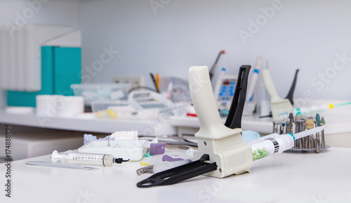  Automix syringe and other tools on dentist table