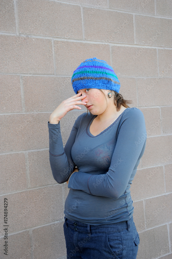 Female beauty expressions against a wall outside. Female beauty expressions against a wall outside.