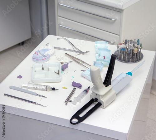  Automix syringe and other tools on dentist table