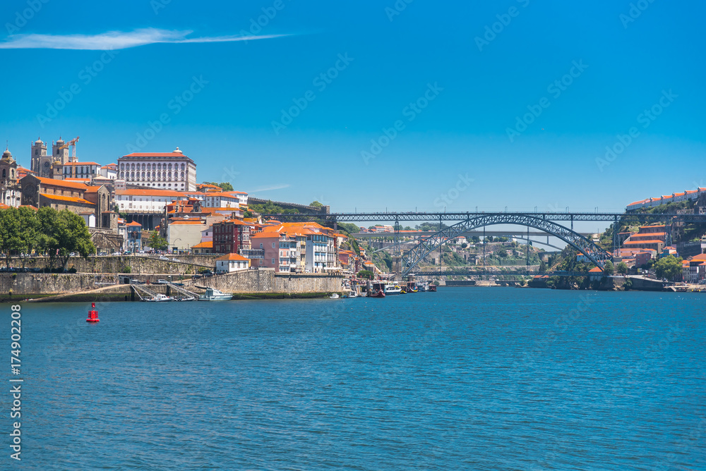 Porto, Portugal, panorama of Dom Luis bridge, the river Douro and tiles roofs 

