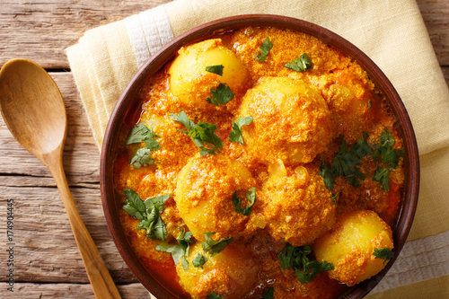 Freshly cooked Indian potatoes Dum aloo in curry sauce close-up. Horizontal top view