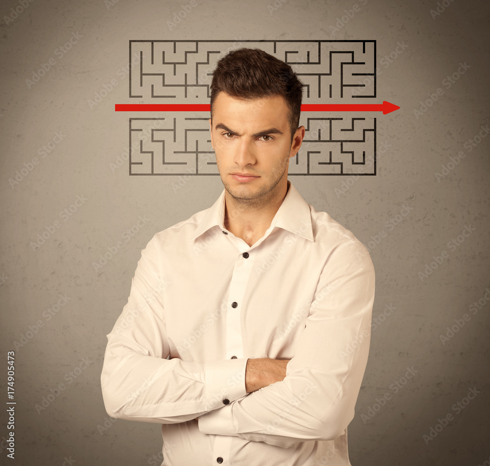 Handsome business guy solving maze Handsome business guy solving maze