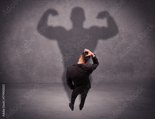 Successful businessman with strong shadow