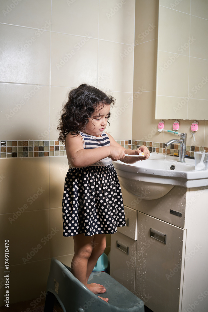 Little beautiful girl brushing teeth in bathroom,.healthy concept Little beautiful girl brushing teeth in bathroom,.healthy concept