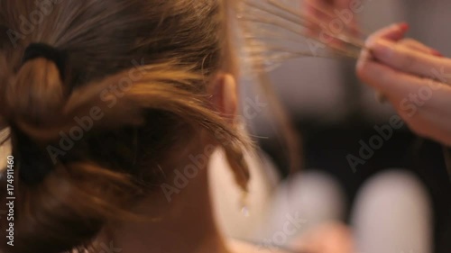 stylist works with the model. Stylist makes the girl-model a luxurious hairstyle. close up