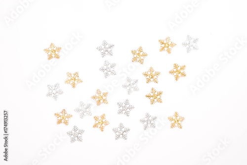 Christmas decorations,  silver snowflakes and gold snowflakes on white background.