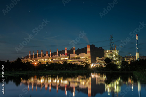 Coal power plant at water front with reflection