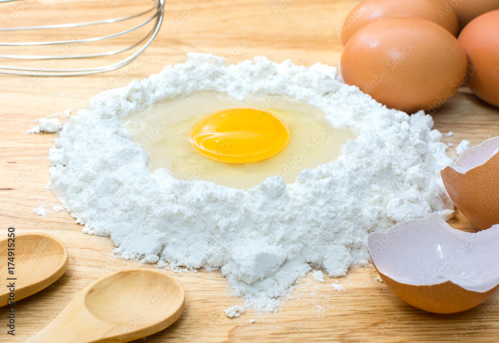 flour with egg and ingredients for homemade bakery on wooden background flour with egg and ingredients for homemade bakery on wooden background