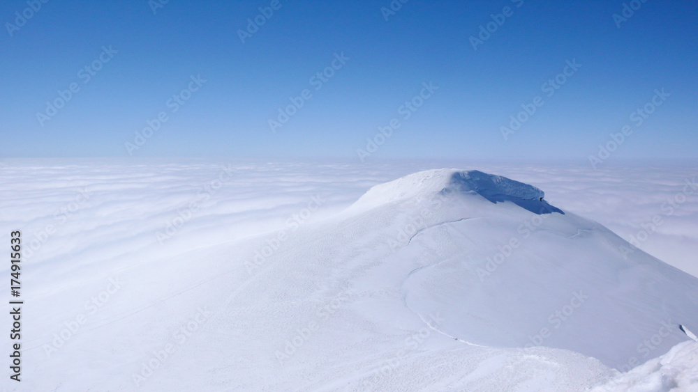 On top of Snaefellsnesjökull, an icy volcano on Iceland. Marvellous blue skies compete with the pure white ice and snow and the white fog covering the Sea.