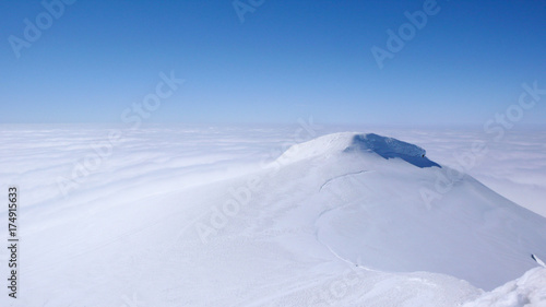 On top of Snaefellsnesjökull, an icy volcano on Iceland. Marvellous blue skies compete with the pure white ice and snow and the white fog covering the Sea. © alffalff