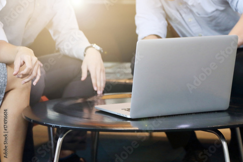 businesspeople discussing in front of laptop