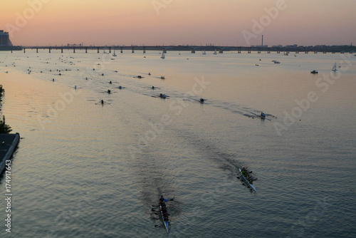 City of the Dniepr, Ukraine (Dnipropetrovsk, Dnepr city, Dnipro). Holiday city day. Regatta 2017 held on the river Dnipro with sunset in the backgrounds. Group of people competition on kayaks. 