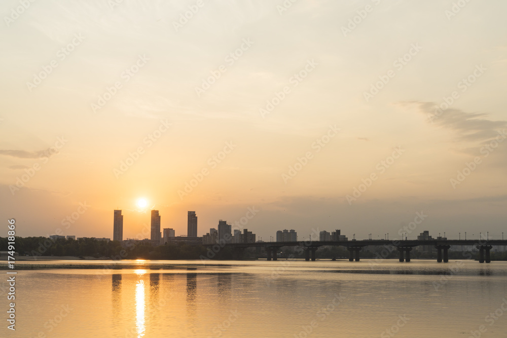 Sunrise over the city and river with bridge