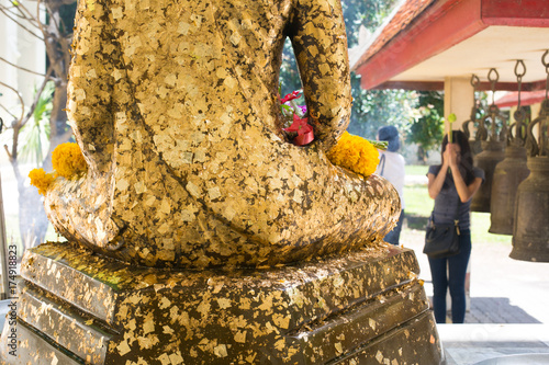 The Buddha statue to gild with gold leaf at thailand temple photo