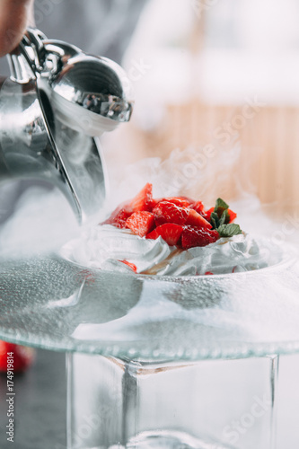 the preparation of the dessert Pavlova with strawberries and in the supply of liquid nitrogen photo