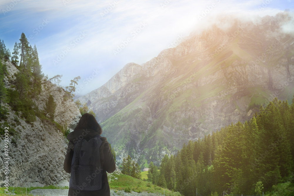 Girl has look at the big mountain and blue sky background in the morning and think how to go. Travel, Adventure and Recreation concept. Girl has look at the big mountain and blue sky background in the morning and think how to go. Travel, Adventure and Recreation concept.