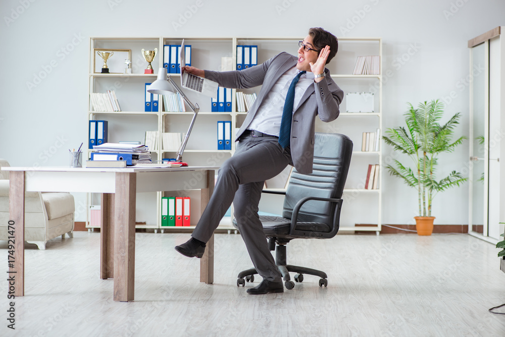Businessman having fun taking a break in the office at work Businessman having fun taking a break in the office at work