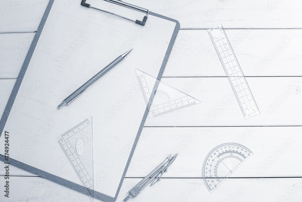 triangle, compass, ruler, protractor on white wooden desk triangle, compass, ruler, protractor on white wooden desk