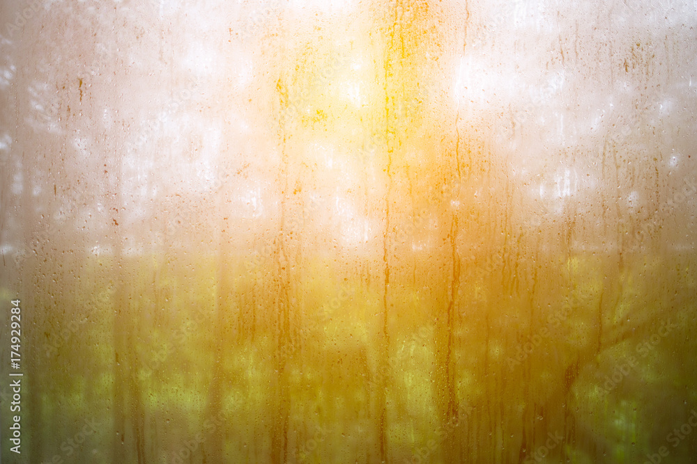 Obraz na plátně Rain drops on window with sun light.